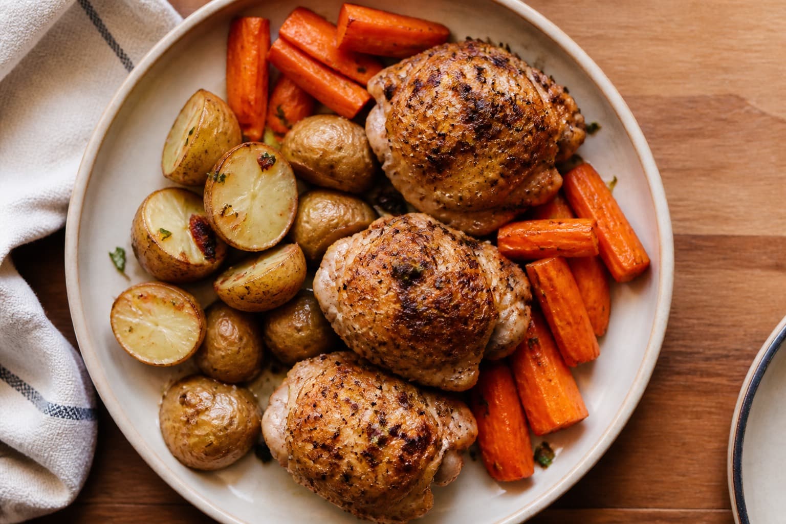 A practical family dinner plate with roasted chicken, potatoes, and carrots